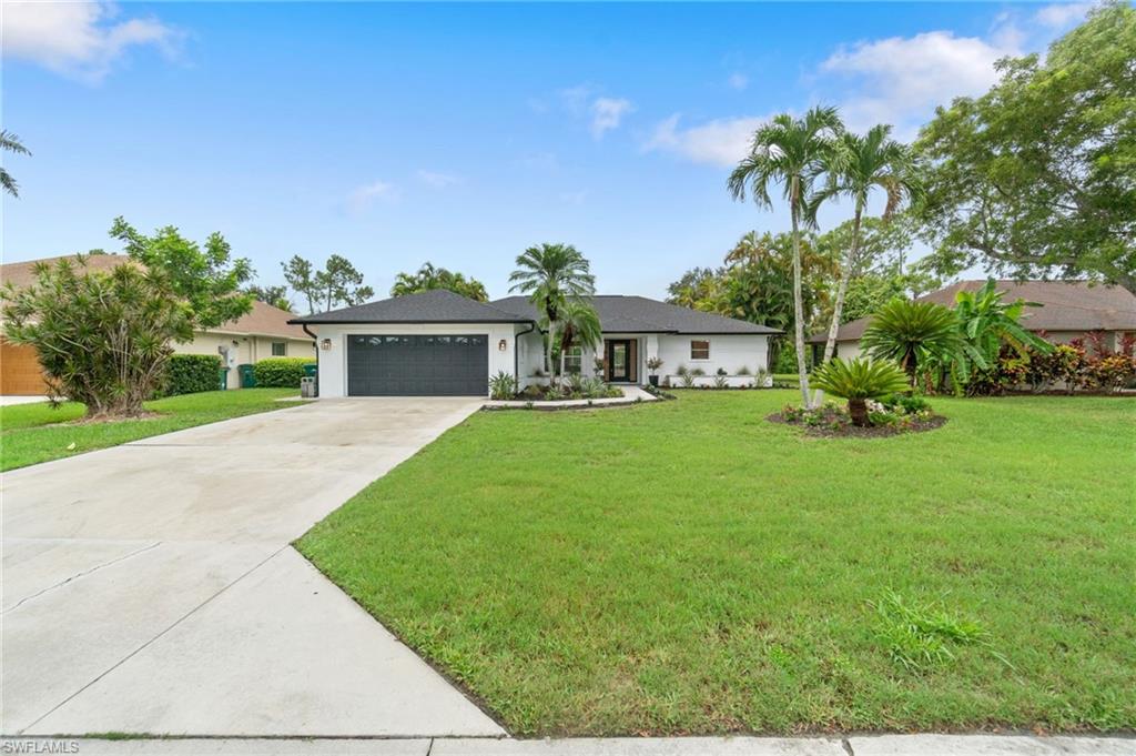548 Ibis Way Naples, FL 34110 - Photo 35 of 45 a front view of a house with garden