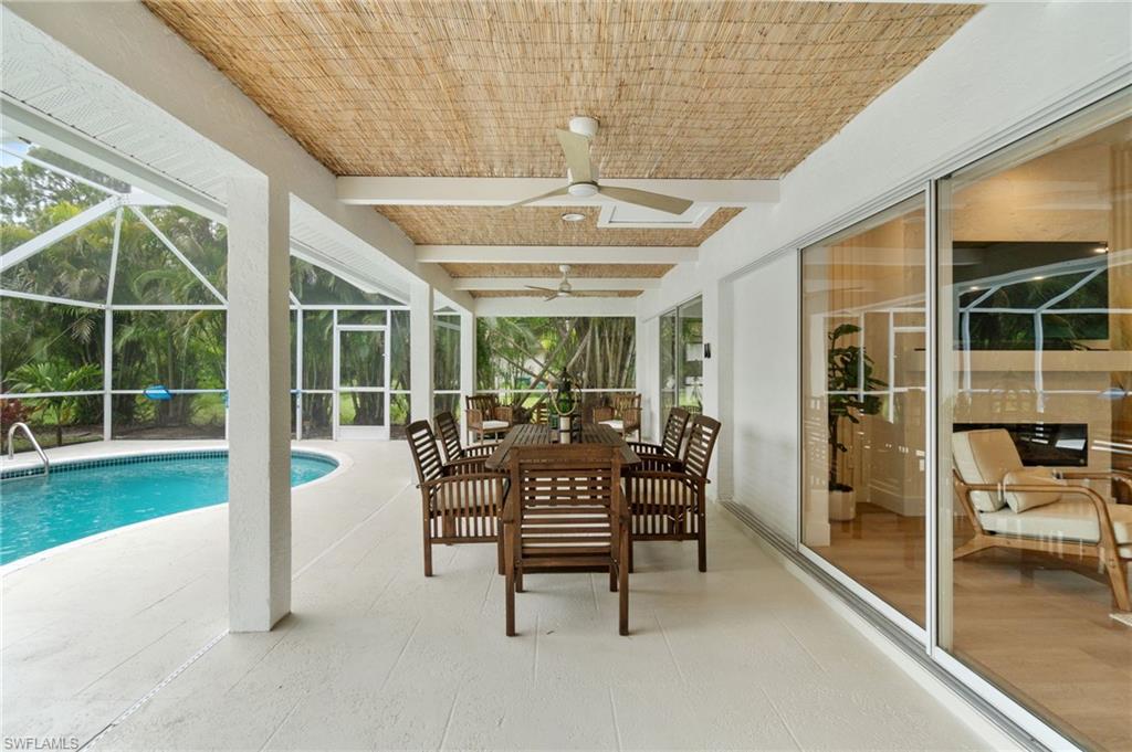 548 Ibis Way Naples, FL 34110 - Photo 37 of 45 a view of a porch with chairs and backyard