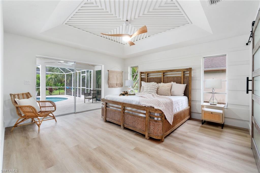 548 Ibis Way Naples, FL 34110 - Photo 4 of 45 a bed room with a bed and a chair