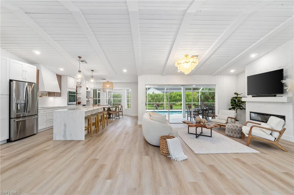 548 Ibis Way Naples, FL 34110 - Photo 7 of 45 a living room with furniture and a flat screen tv