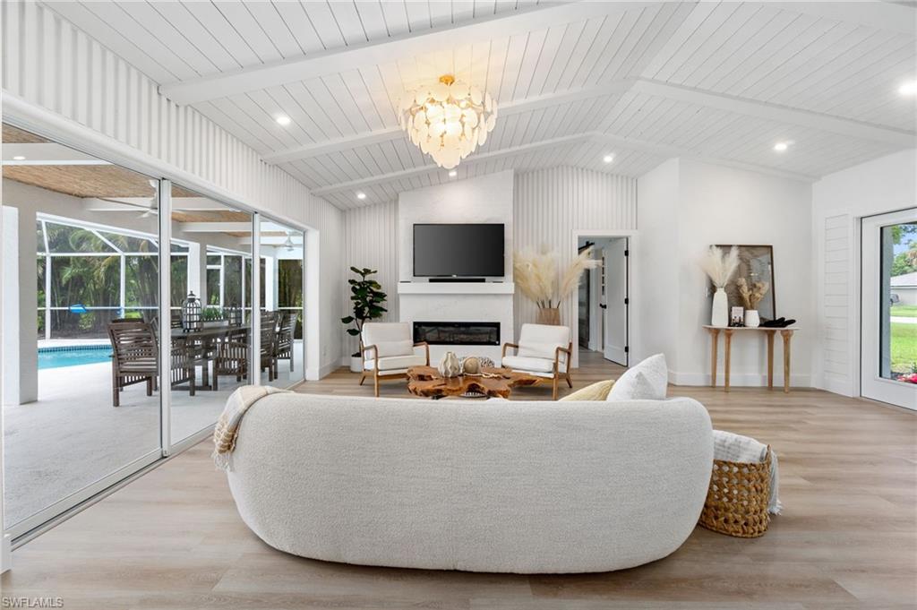 548 Ibis Way Naples, FL 34110 - Photo 8 of 45 a living room with fireplace furniture and a flat screen tv