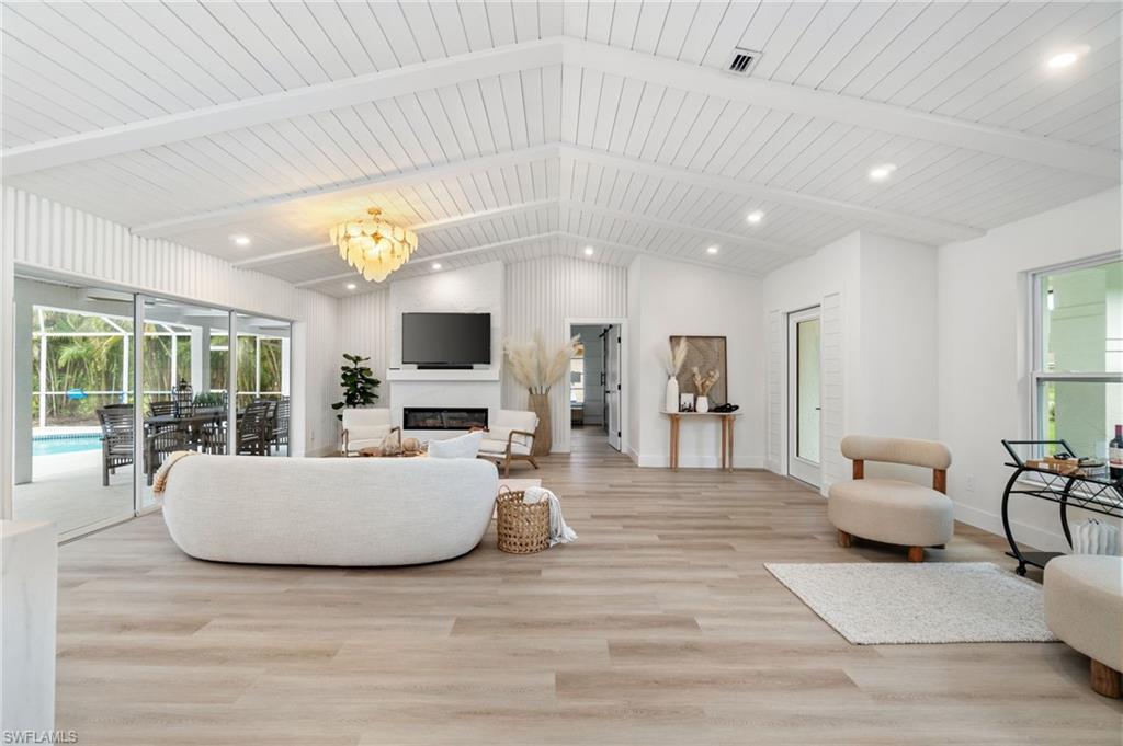 548 Ibis Way Naples, FL 34110 - Photo 9 of 45 a living room with furniture and a flat screen tv