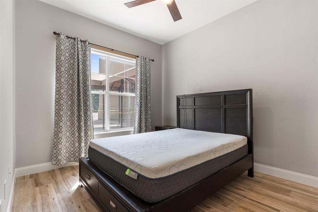 3102 Kings Road, Unit 1106 Dallas, TX 75219 - Photo 11 of 20 a bedroom with a bed and wooden floor