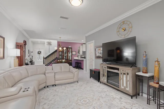 a view of a bedroom with a large bed and wooden floor