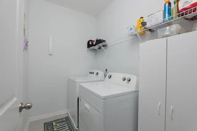 an aerial view of ocean and residential houses with outdoor space