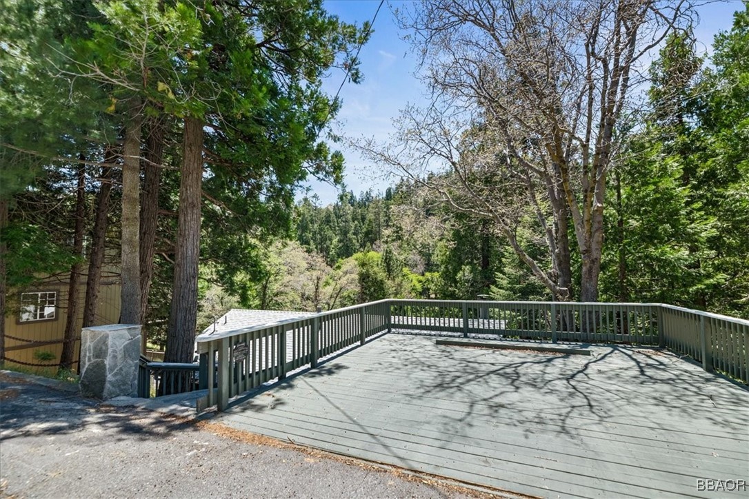 24755 Basel Drive Crestline, CA 92325 - Photo 28 of 28 a view of a roof deck with wooden fence and trees