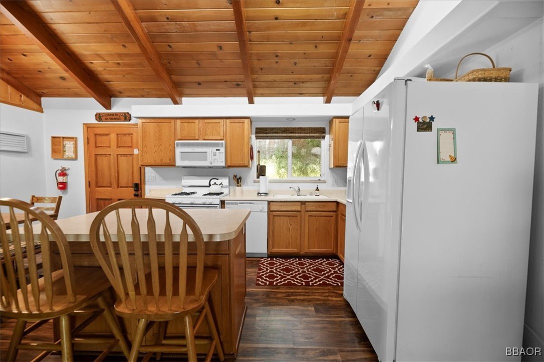 24755 Basel Drive Crestline, CA 92325 - Photo 9 of 28 a kitchen with stainless steel appliances kitchen island granite countertop a table and chairs