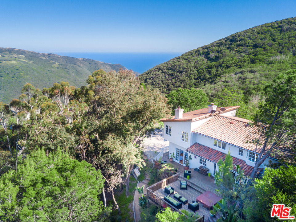an aerial view of a house with a garden