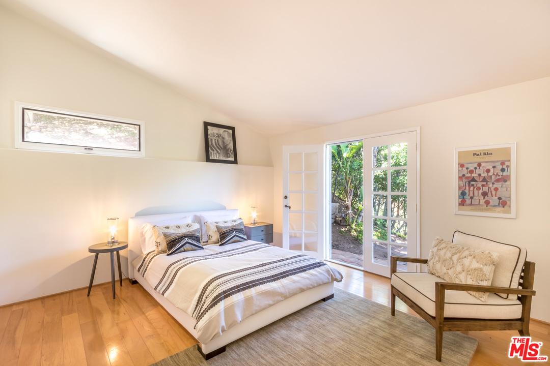 2382 Live Oak Meadows Road Malibu, CA 90265 - Photo 14 of 27 a bedroom with a bed and a couch