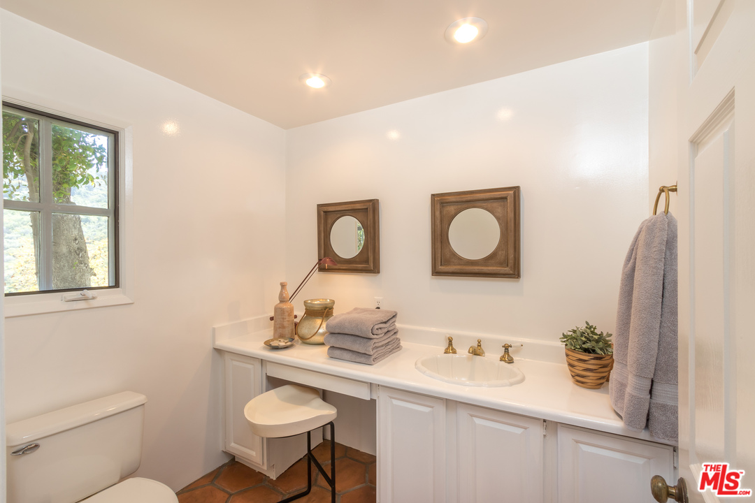 2382 Live Oak Meadows Road Malibu, CA 90265 - Photo 18 of 27 a bathroom with a toilet a sink and mirror