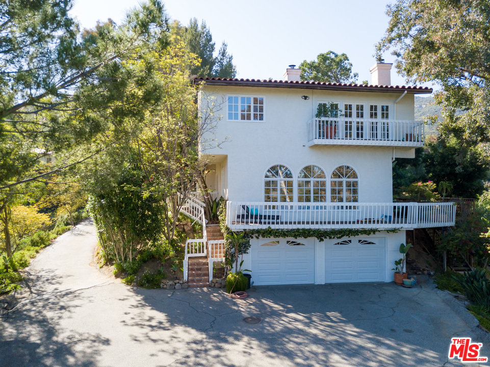 2382 Live Oak Meadows Road Malibu, CA 90265 - Photo 20 of 27 a view of a house with a yard and sitting area