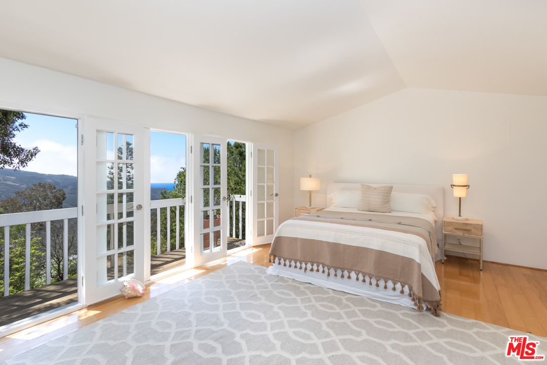 2382 Live Oak Meadows Road Malibu, CA 90265 - Photo 8 of 27 a spacious bedroom with a bed and a window