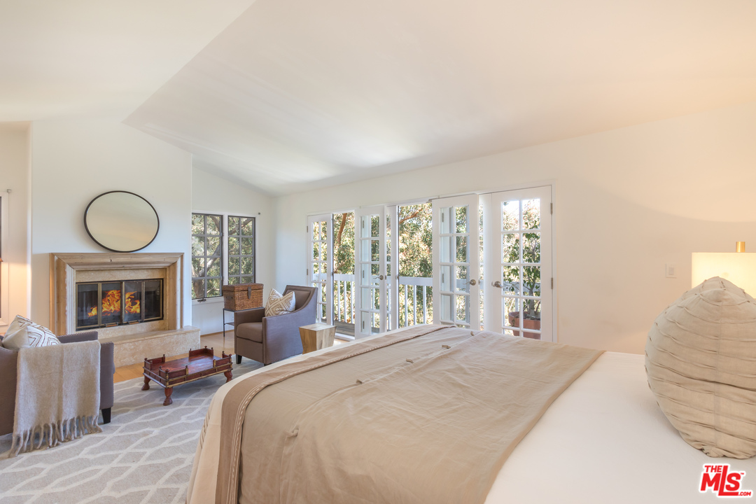 2382 Live Oak Meadows Road Malibu, CA 90265 - Photo 9 of 27 a bedroom with furniture and a large window