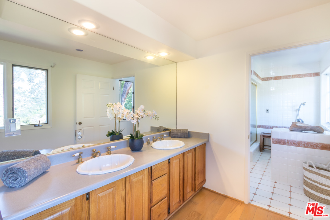 2382 Live Oak Meadows Road Malibu, CA 90265 - Photo 10 of 27 a room with two sink and chair