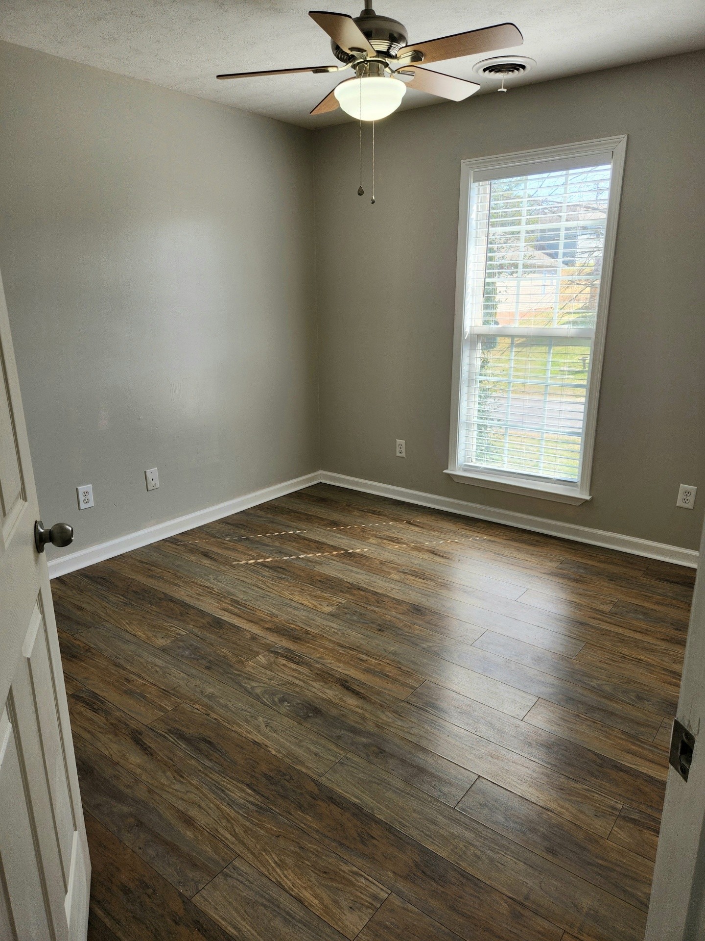 419 Berry Circle Springfield, TN 37172 - Photo 16 of 19 an empty room with wooden floor fan and windows