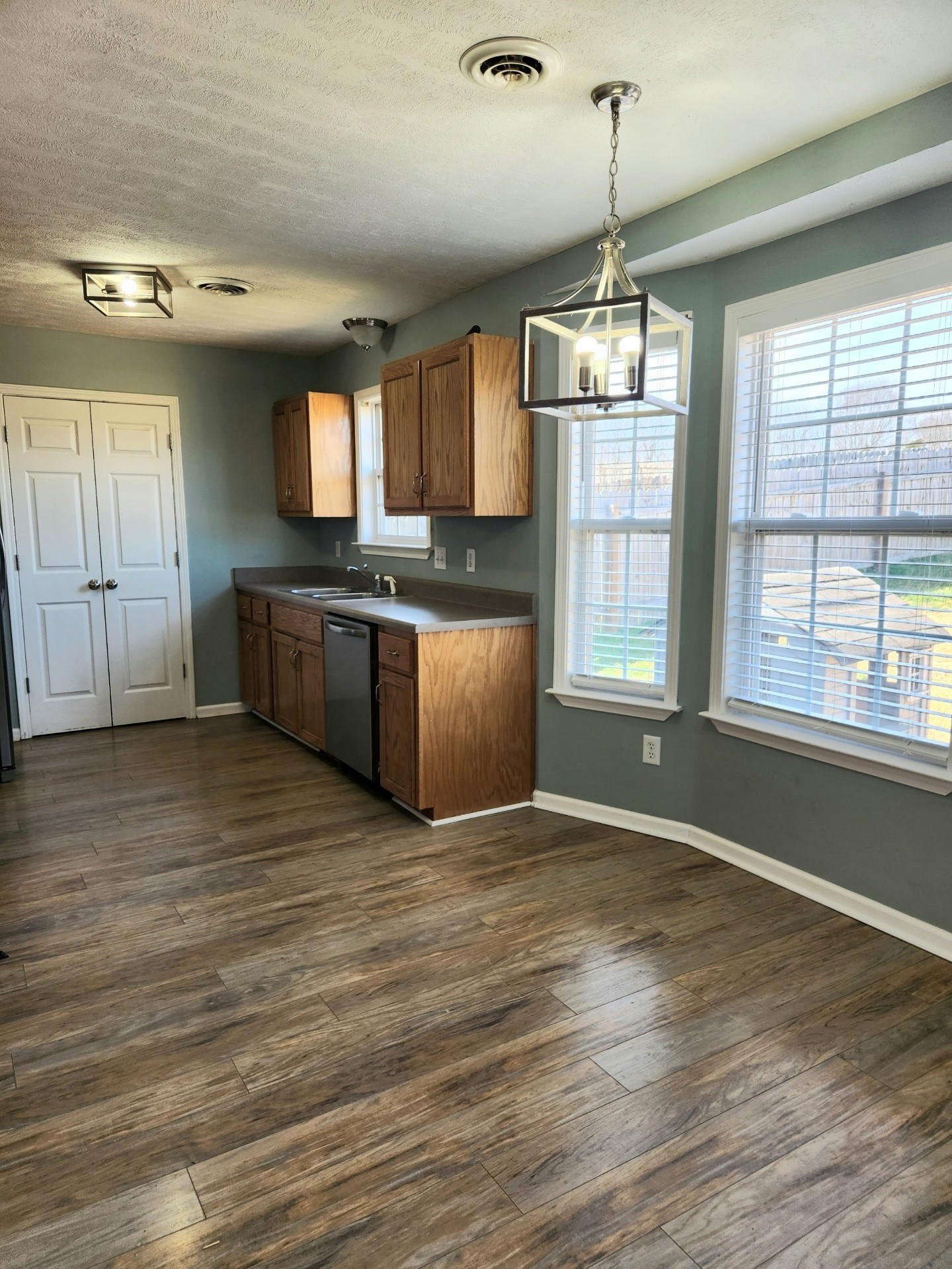 419 Berry Circle Springfield, TN 37172 - Photo 5 of 19 a kitchen with stainless steel appliances granite countertop a stove top oven a sink dishwasher a refrigerator and a dining table with wooden floor