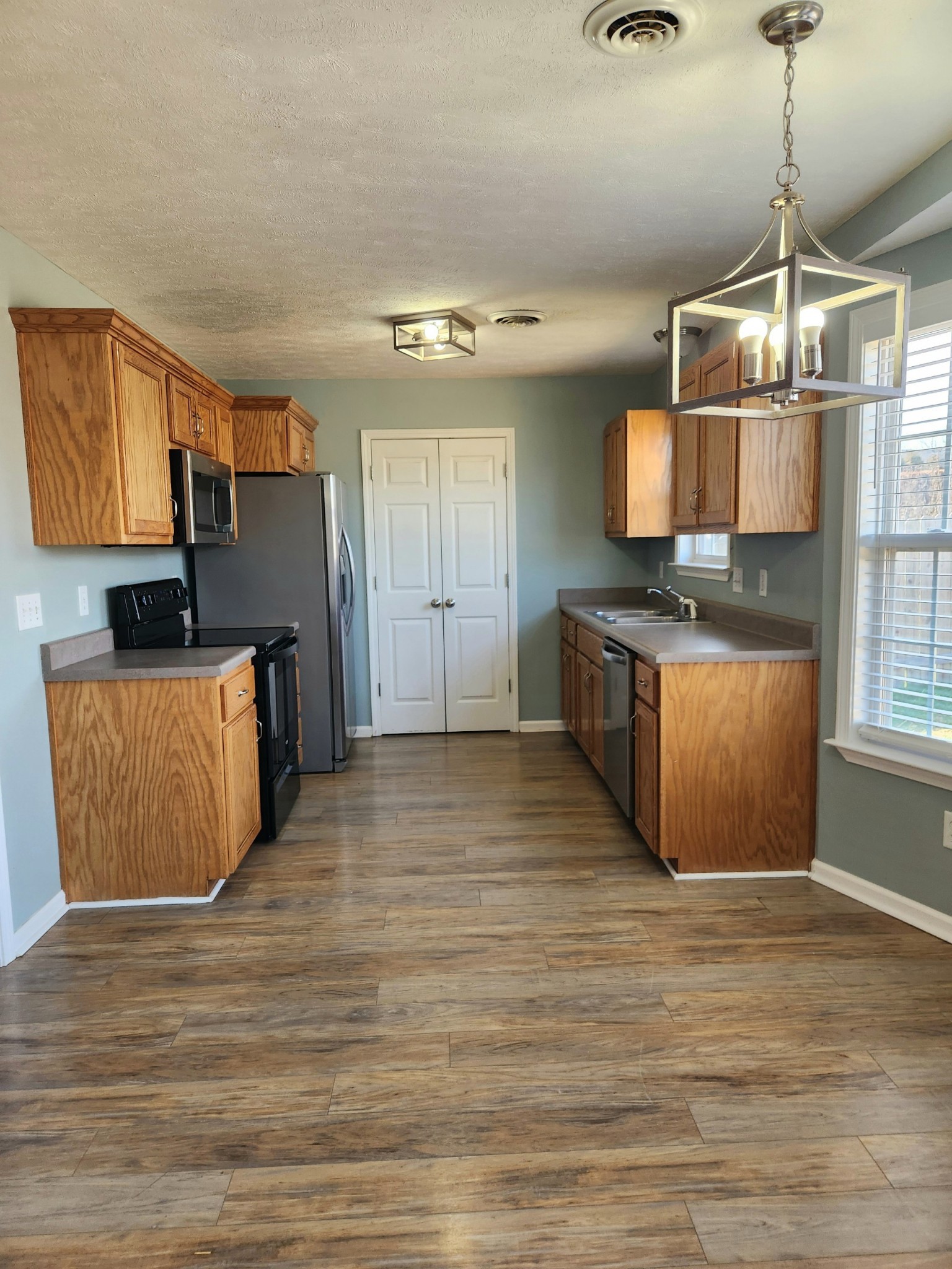 419 Berry Circle Springfield, TN 37172 - Photo 6 of 19 a kitchen with stainless steel appliances granite countertop a oven a stove and a wooden floors