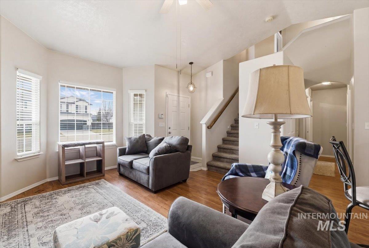 1896 West Ridge Pointe Avenue Nampa, ID 83651 - Photo 11 of 49 Living room with wood finished floors, a ceiling fan, and arched walkways