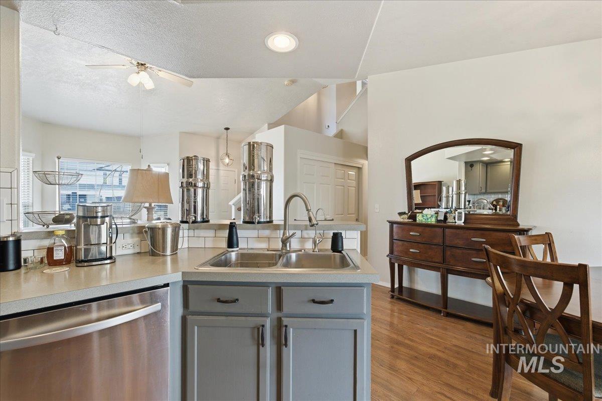1896 West Ridge Pointe Avenue Nampa, ID 83651 - Photo 17 of 49 Kitchen featuring dishwasher, light countertops, ceiling fan, gray cabinets, and dark wood-type flooring