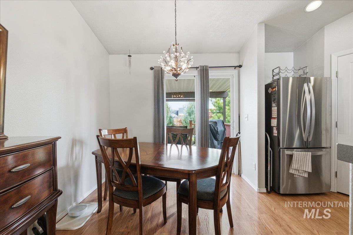 1896 West Ridge Pointe Avenue Nampa, ID 83651 - Photo 19 of 49 Dining area with light wood finished floors and suspended lighting