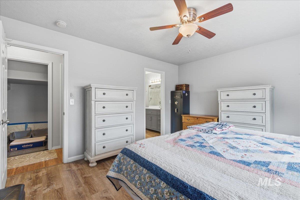 1896 West Ridge Pointe Avenue Nampa, ID 83651 - Photo 21 of 49 Bedroom with light wood-type flooring, a ceiling fan, ensuite bath, and a textured ceiling