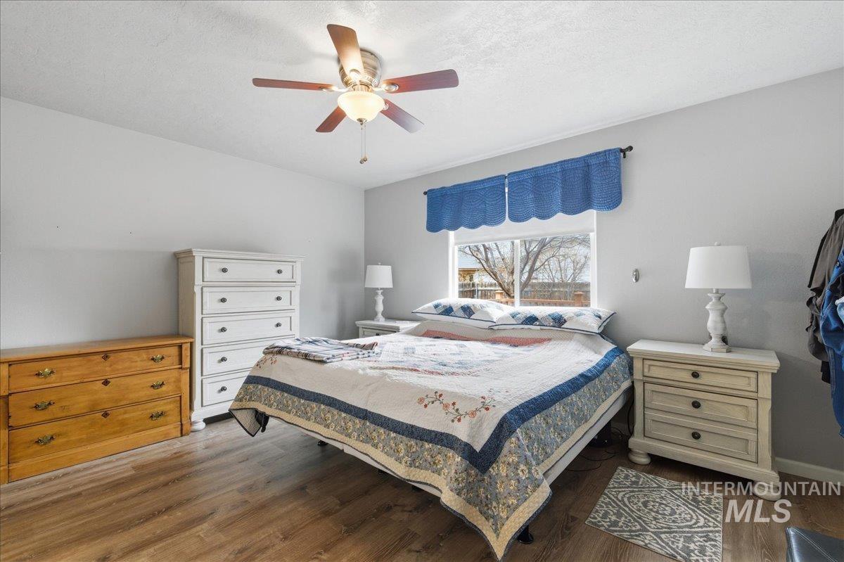 1896 West Ridge Pointe Avenue Nampa, ID 83651 - Photo 22 of 49 Bedroom featuring dark wood-type flooring, a ceiling fan, and a textured ceiling