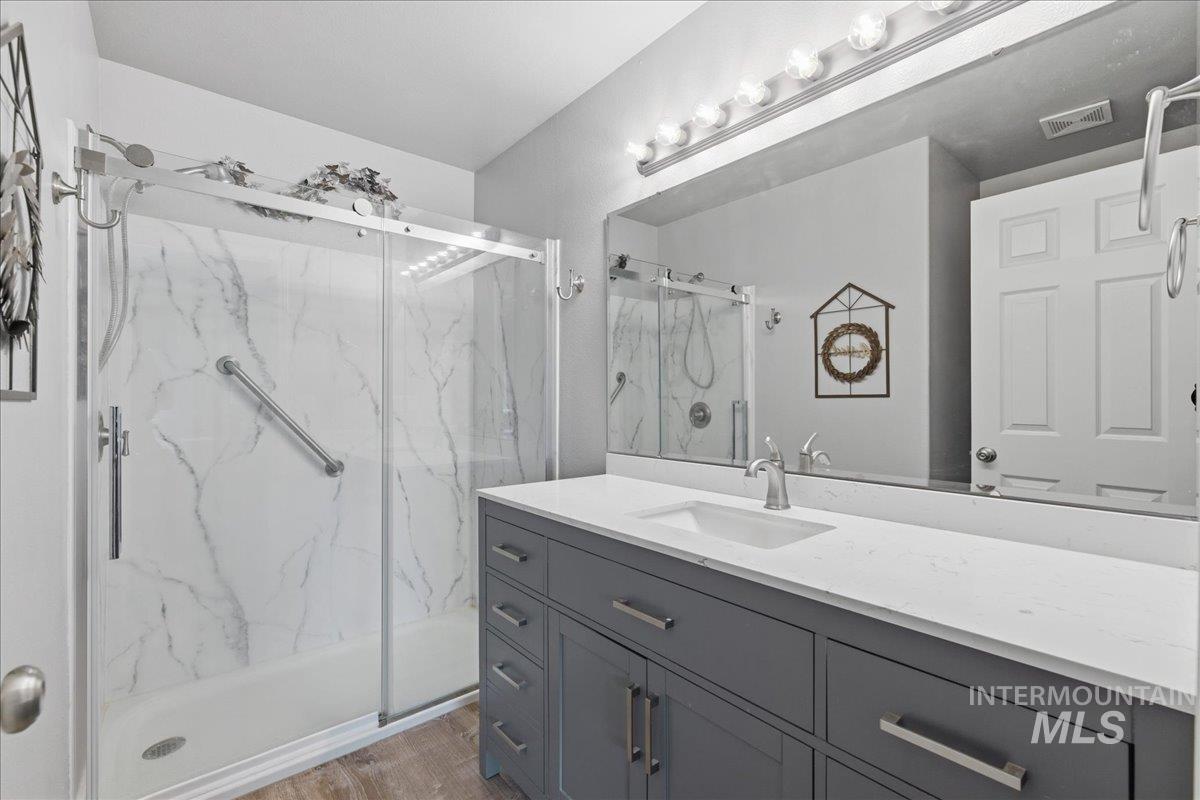 1896 West Ridge Pointe Avenue Nampa, ID 83651 - Photo 23 of 49 Bathroom featuring vanity and a marble finish shower