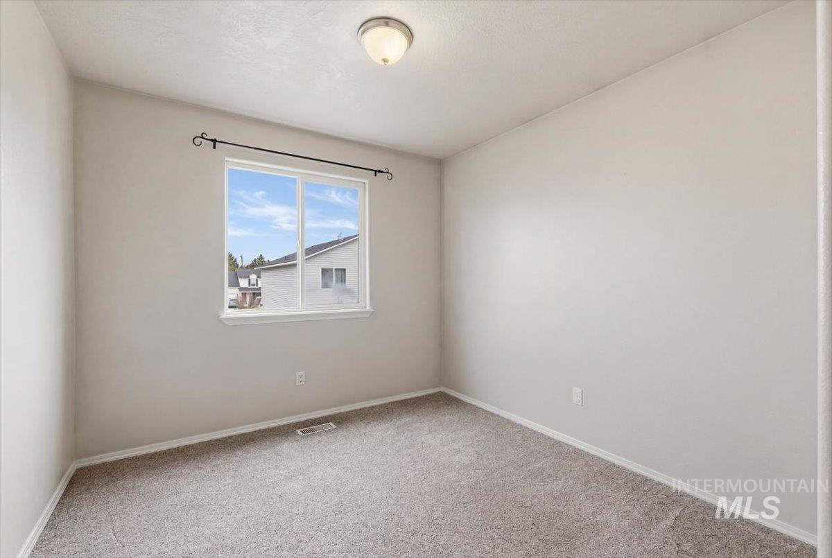 1896 West Ridge Pointe Avenue Nampa, ID 83651 - Photo 25 of 49 Unfurnished room with light colored carpet and baseboards