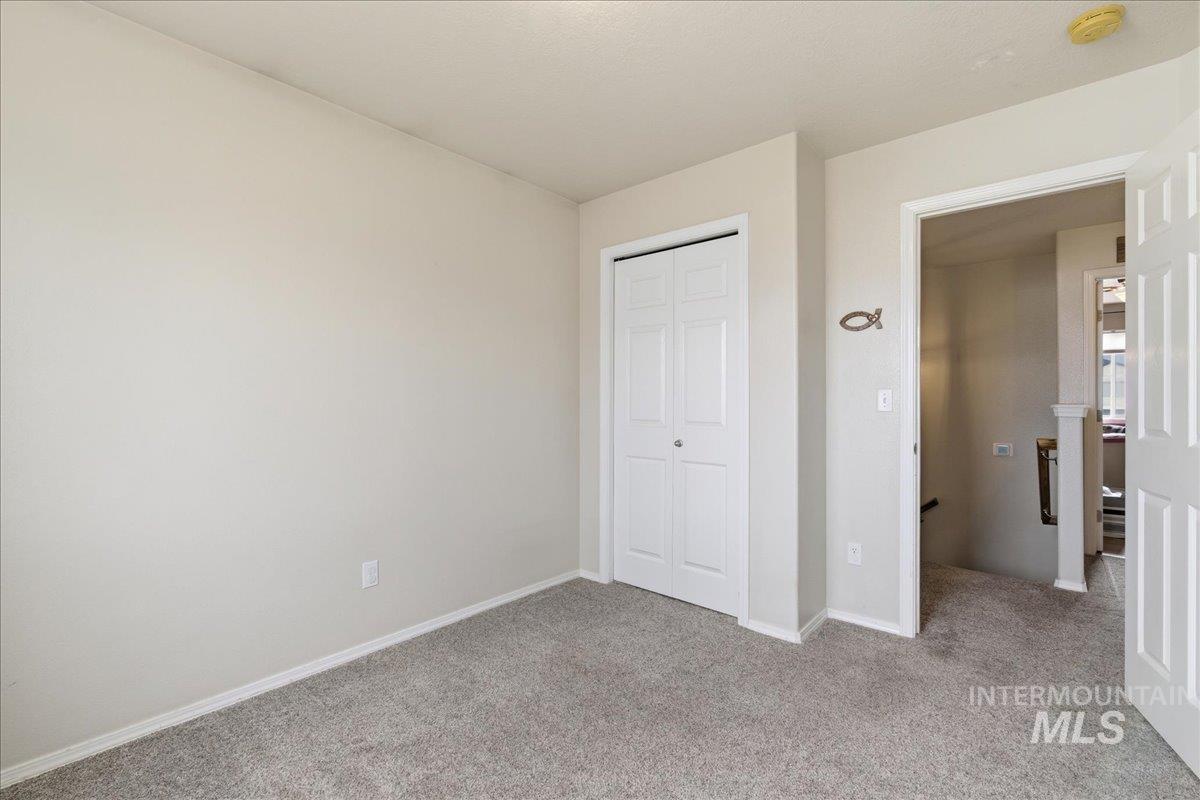 1896 West Ridge Pointe Avenue Nampa, ID 83651 - Photo 34 of 49 Unfurnished bedroom with light colored carpet and a closet