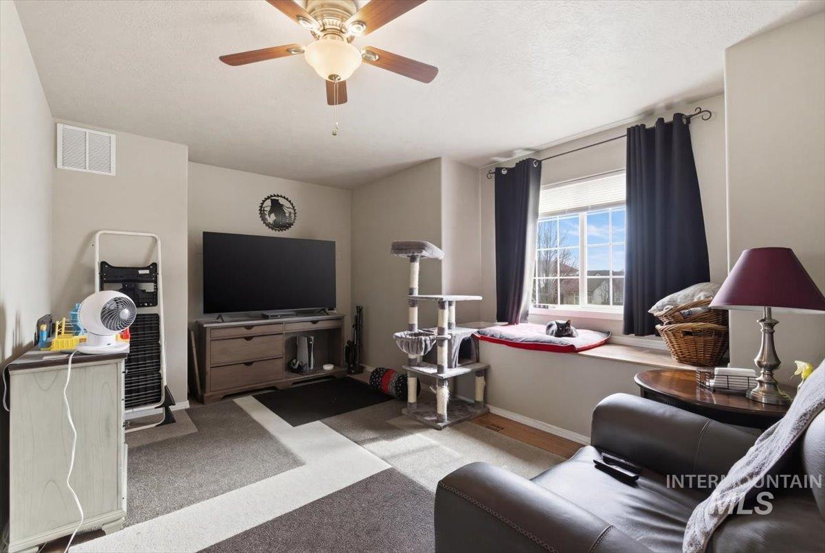 1896 West Ridge Pointe Avenue Nampa, ID 83651 - Photo 35 of 49 Living area with ceiling fan and light colored carpet