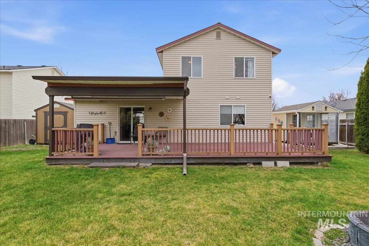 1896 West Ridge Pointe Avenue Nampa, ID 83651 - Photo 37 of 49 Back of house featuring a storage unit and a wooden deck