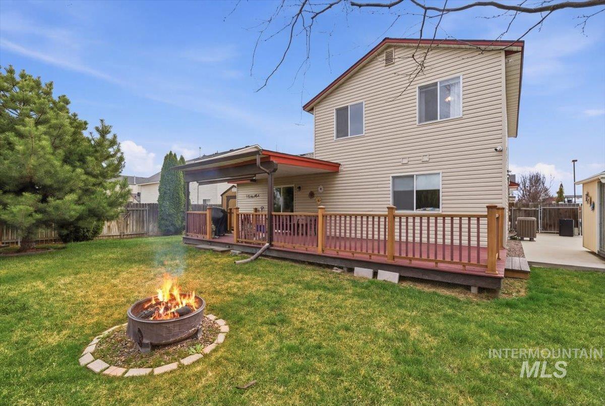 1896 West Ridge Pointe Avenue Nampa, ID 83651 - Photo 38 of 49 Rear view of property with a deck, a fenced backyard, and an outdoor fire pit