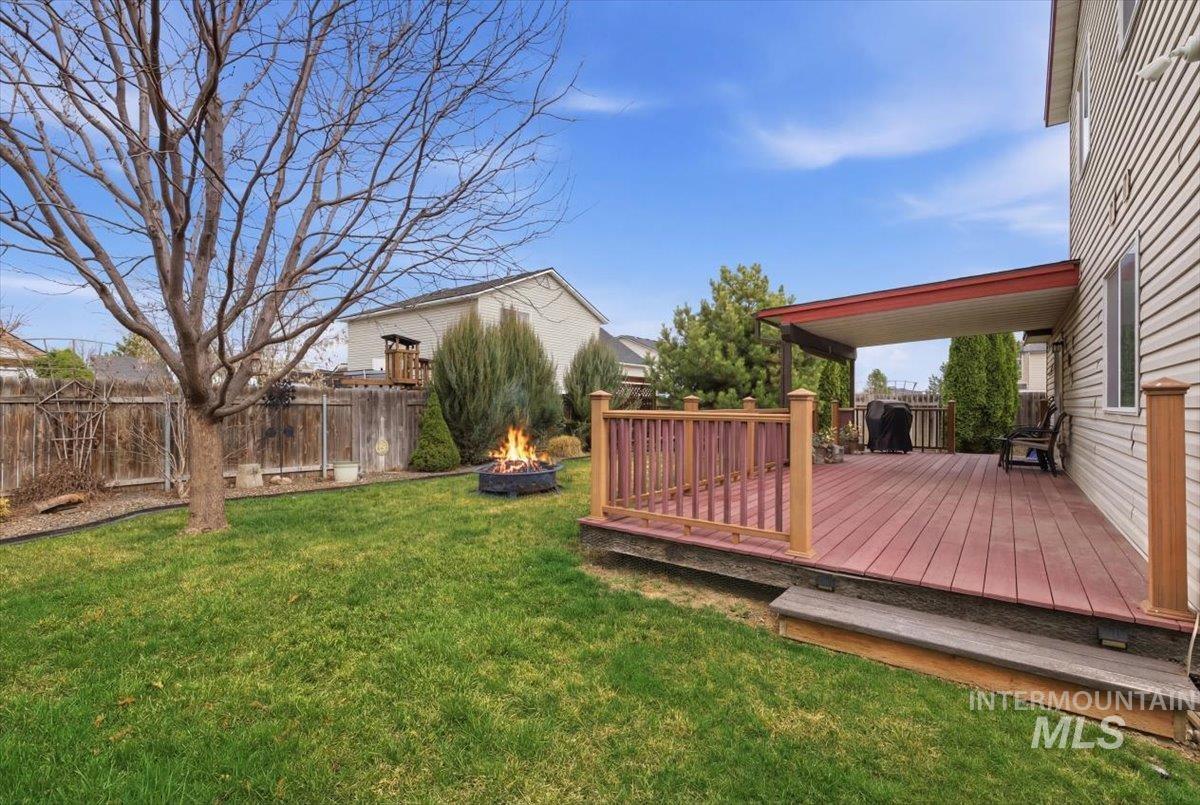 1896 West Ridge Pointe Avenue Nampa, ID 83651 - Photo 39 of 49 Fenced backyard featuring a deck and an outdoor fire pit