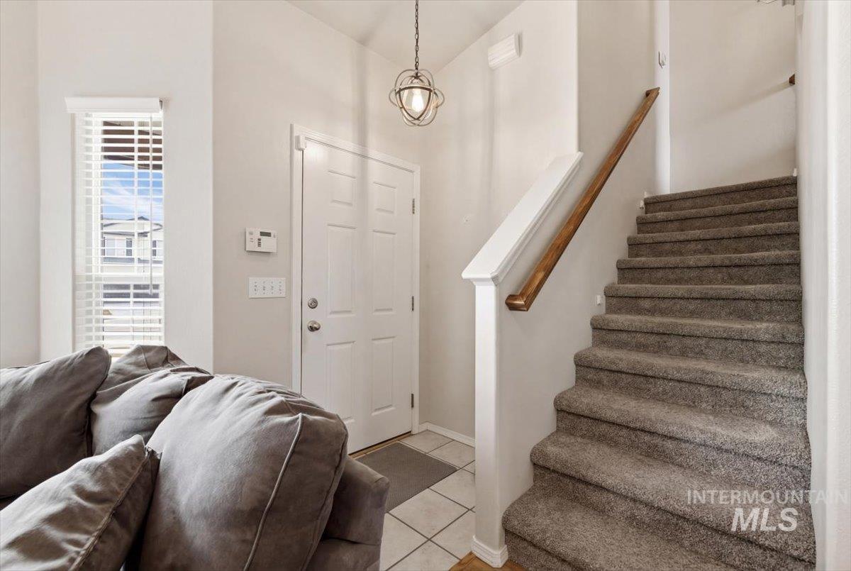 1896 West Ridge Pointe Avenue Nampa, ID 83651 - Photo 6 of 49 Foyer entrance featuring stairs and light tile patterned floors