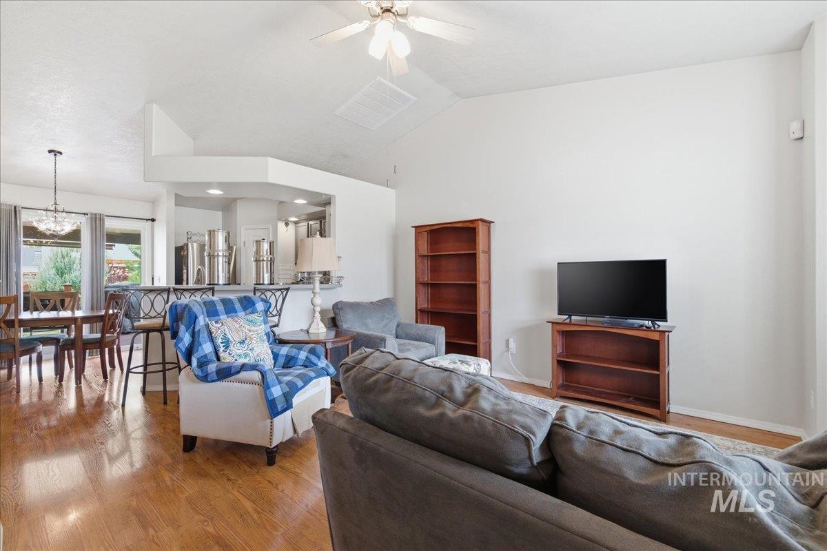 1896 West Ridge Pointe Avenue Nampa, ID 83651 - Photo 7 of 49 Living area featuring wood finished floors, ceiling fan, suspended lighting, and vaulted ceiling