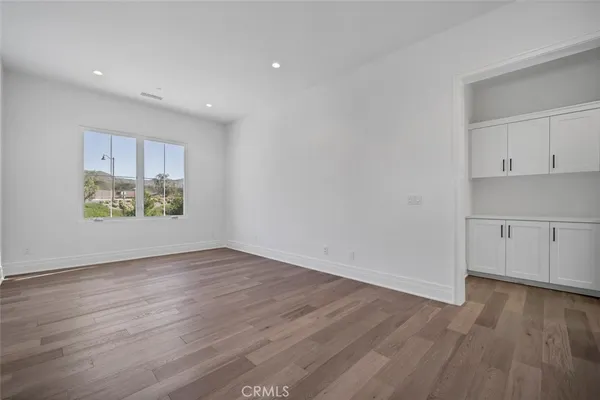 a view of an empty room and wooden floor