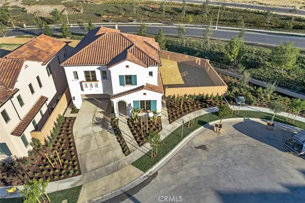 an aerial view of a house with a yard