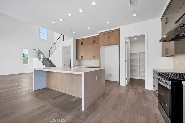a kitchen with kitchen island a sink stainless steel appliances and cabinets