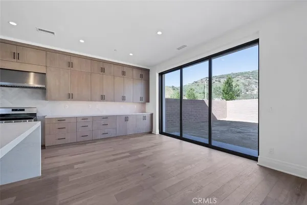 a view of a kitchen with large windows