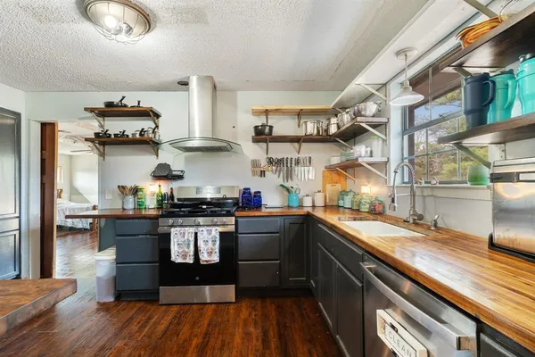 a kitchen with stainless steel appliances granite countertop a stove and a sink
