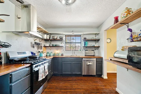 a kitchen with stainless steel appliances granite countertop a stove and a sink