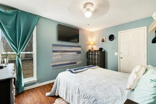 a bedroom with a bed and a flat screen tv