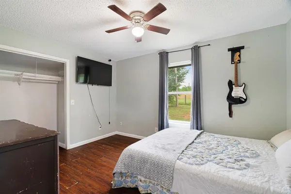 a bedroom with a bed and a flat screen tv