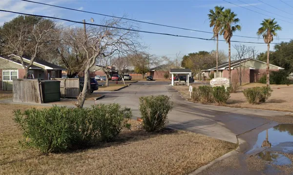 a view of a street with a house in the background