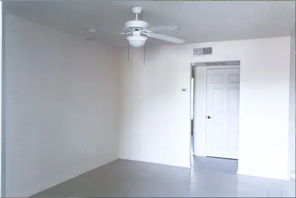 a view of a small space with a chandelier fan