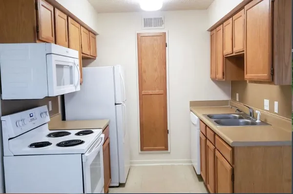 a kitchen with a stove and a refrigerator