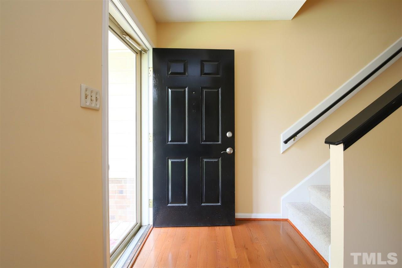 6708 Chauncey Drive Raleigh, NC 27615 - Photo 2 of 25 a view of hallway with wooden floor and door