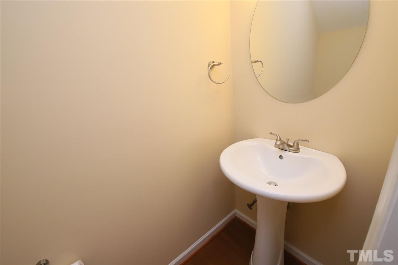 6708 Chauncey Drive Raleigh, NC 27615 - Photo 11 of 25 a bathroom with a sink and mirror