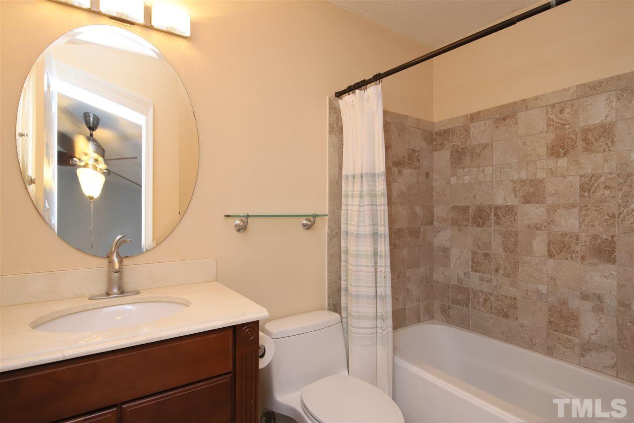 6708 Chauncey Drive Raleigh, NC 27615 - Photo 14 of 25 a bathroom with a sink toilet and shower