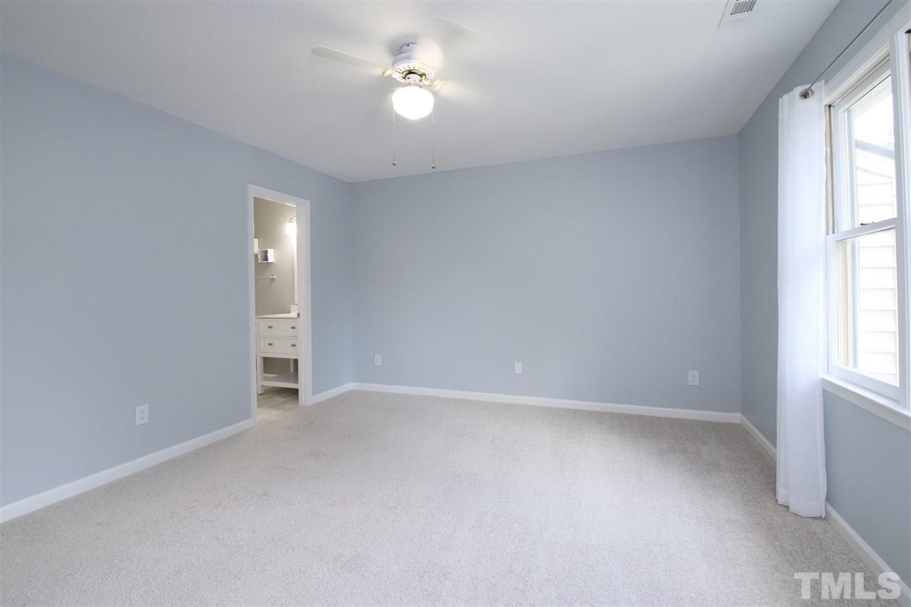 6708 Chauncey Drive Raleigh, NC 27615 - Photo 16 of 25 wooden floor in an empty room with a window